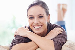 Woman on couch with brilliant white smile