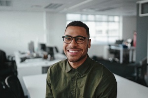 Man smiling while in an office in Lewisville