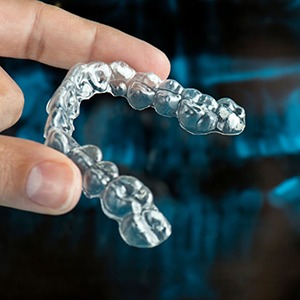 person holding Invisalign in Lewisville