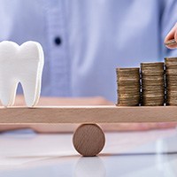 A tooth and money on a scale