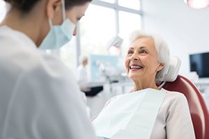 Senior woman talking with dental team member