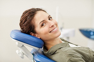 A woman smiling in a dentist’s chair