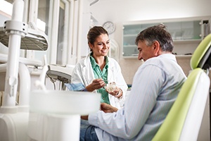 Dentist talking to patient about dentures