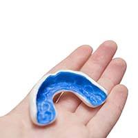 Person holding a custom-made mouthguard