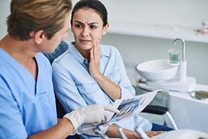 Emergency dentist in Lewisville speaking to a patient