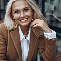 Mature professional woman smiling while sitting at table