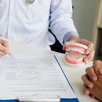 Dentist explaining cost of dental implants in Lewisville to patient