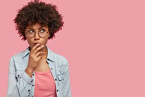 Thinking woman holding her chin with her hand