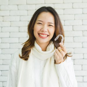 Woman with Invisalign tray