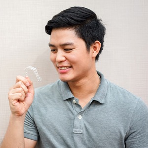 Man with Invisalign tray