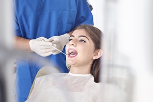 Woman in dental chair receiving oral cancer screening