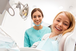 Happy girl smiling in dental chair