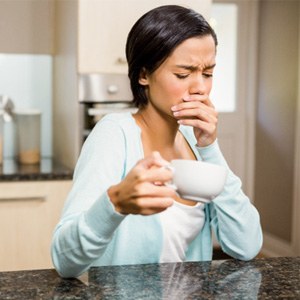 woman coffee toothache for root canal therapy in Lewisville