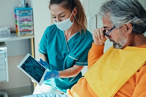 a dentist showing a patient an X-ray of his teeth