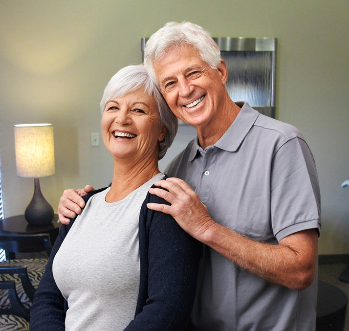 Smiling older man holding woman