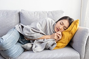 Lady sleeps on couch