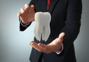 man holding digital tooth