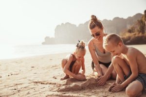 parent building sandcastle with children