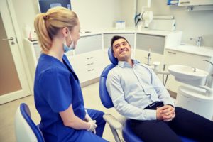 man smiling at emergency dentist in Lewisville