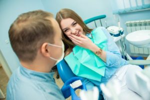 young woman smiling at her dentist in Lewisville