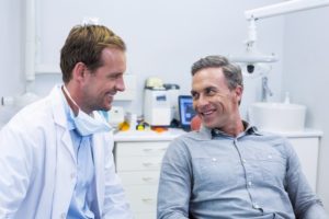 Man happily talks with his friendly Lewisville dentist