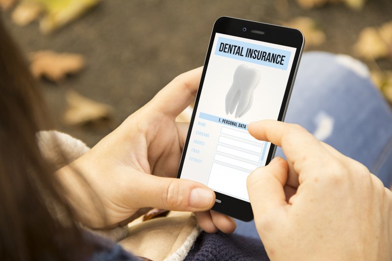 patient looking at dental insurance on phone