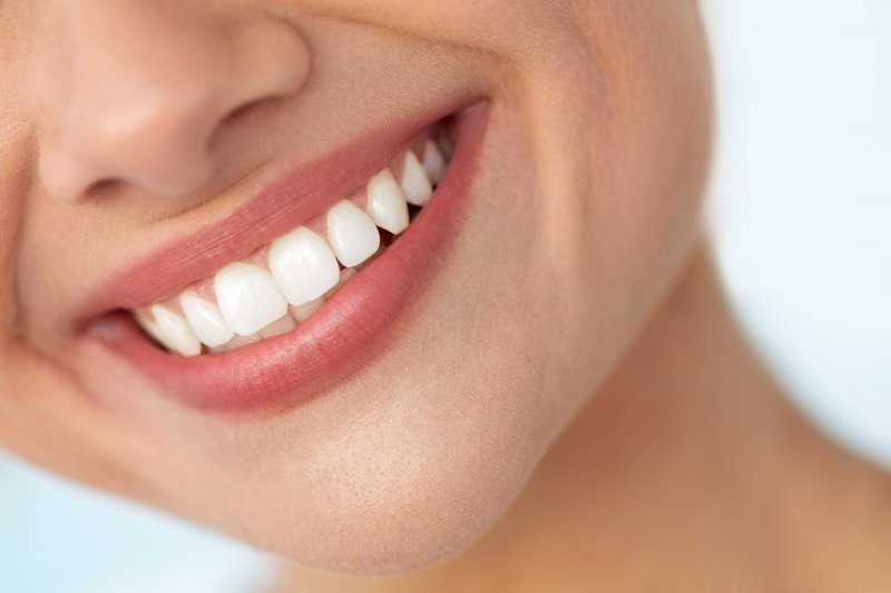 Woman smiling after receiving gum disease therapy