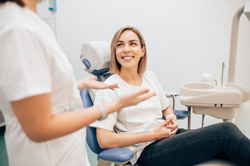 patient at dentist’s office smiling after receiving root canal