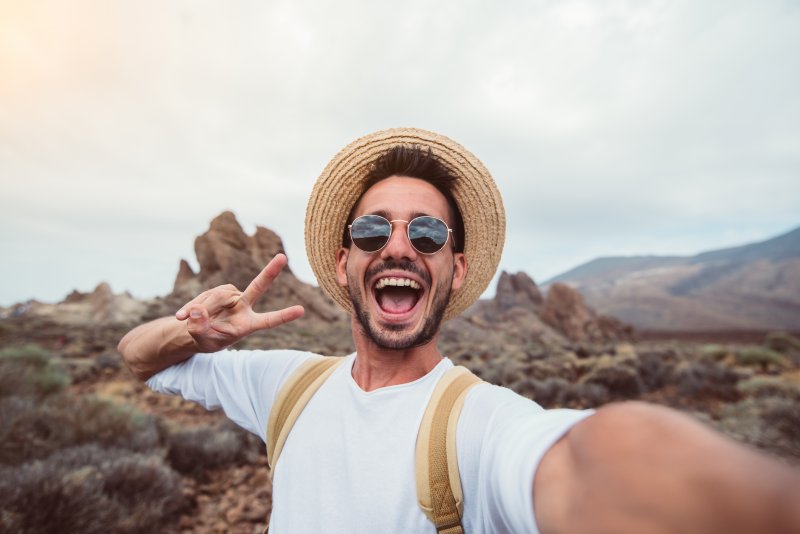 man enjoying vacation after visiting emergency dentist in Lewisville