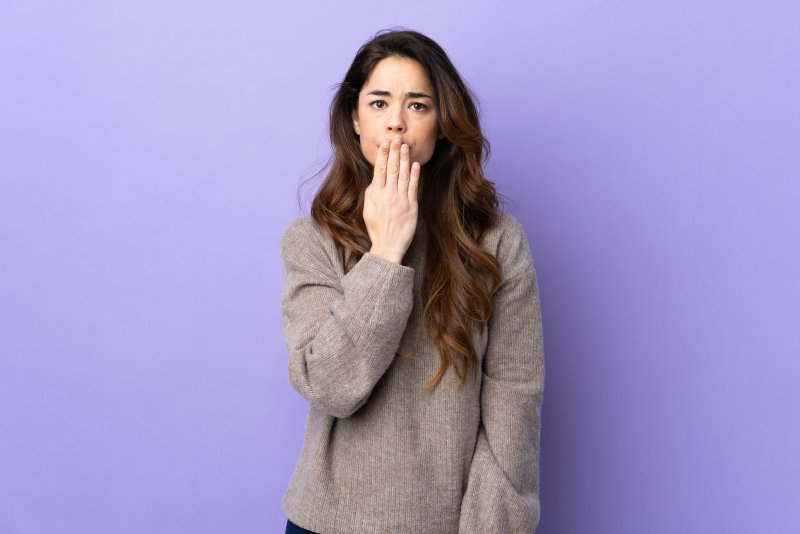 woman covering a chipped tooth in Lewisville