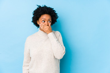 Woman in white sweater covering her mouth