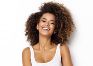 a woman smiling with all the traits of beautiful teeth and gums