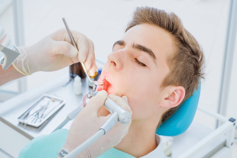 A young man undergoing root canal treatment