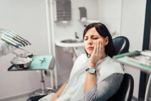 Woman with toothache about to get a root canal to treat infected tooth