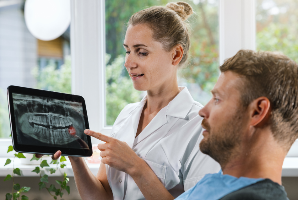 Dentist showing patient wisdom teeth x-ray